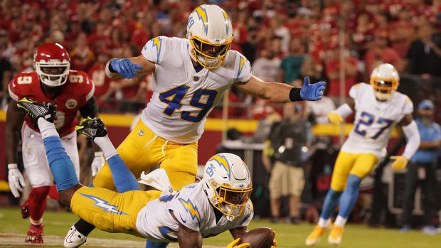 Sep 15, 2022; Kansas City, Missouri, USA; Los Angeles Chargers cornerback Asante Samuel Jr. (26) intercepts a pass against Kansas City Chiefs quarterback Patrick Mahomes (15) during the second half at GEHA Field at Arrowhead Stadium.